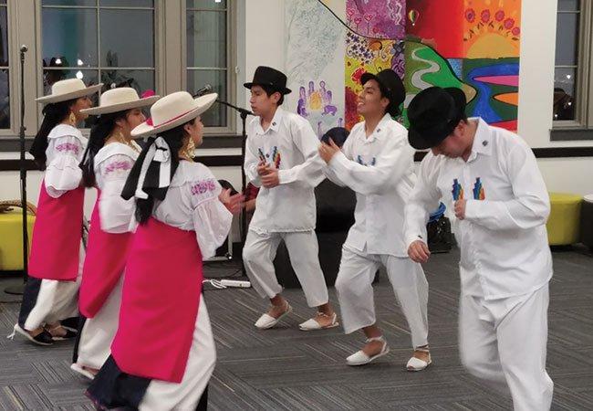 A group of people in hats dancing